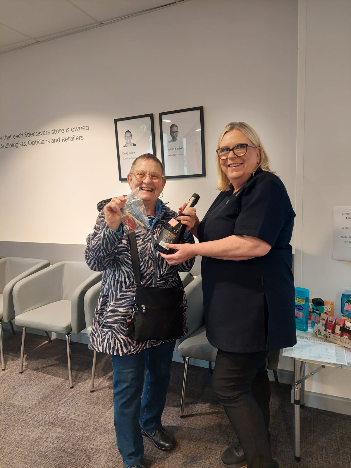 Dionne Gibbons presenting a raffle prize to a customer